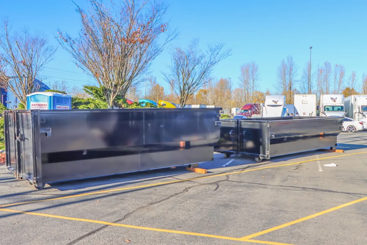 Professional dumpster rental service with roll-off container on residential driveway in Franklin Park